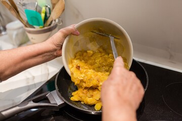 Woman cooking a potato omelet