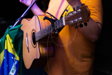 A broken steel string on an acoustic guitar.