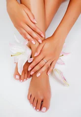 Zelfklevend Fotobehang manicure pedicure with flower lily closeup isolated on white perfect shape hands spa salon © iordani