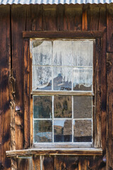 Montana, Virginia City. Detail of a window in vintage cabin.