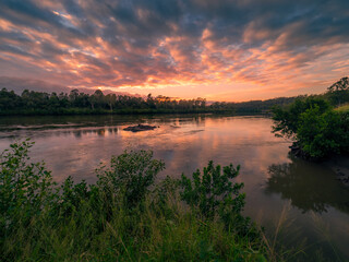 Riverside Sunrise with Cloud Reflections