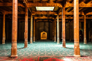 interior with wooden columns and carpet , rhomboid doors, famous landmark in ughur region, nice place for tourists
