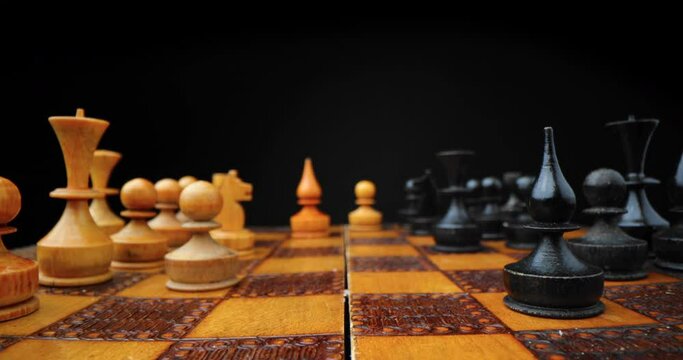 Chess figures on wooden board, 4K video. Business strategy and success.	Game.