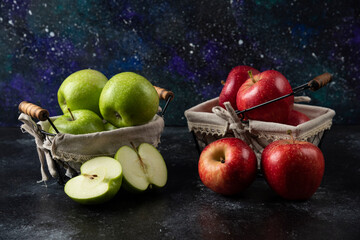 Ripe organic red and green apples in metal baskets