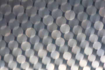 The metal mesh is dark blue, matte in a small circle. Blurred background, defocus.