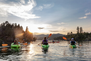 Family sea kayaking on Flathead Lake in Somers, Montana, USA 