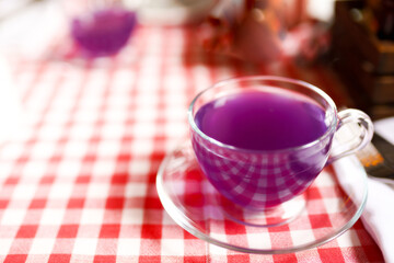 Cup tea of viola flowers, cinnamon and ginger. selective focus