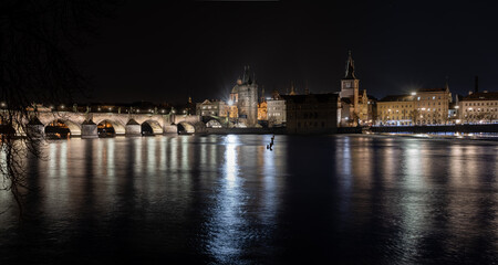 Fototapeta na wymiar view of the illuminated stone Charles Bridge on the Vltava River in the center of Prague at night
