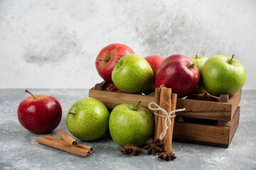 Whole delicious green and red apples in wooden box