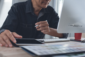 Man graphic designer working on computer and digital tablet at office - Powered by Adobe