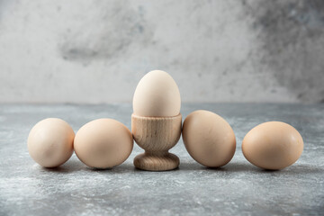 Bunch of raw eggs on marble table