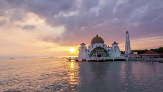 Dramatic sunset view at Majestic Glowing Strait Mosque of Malacca, Malaysia. The mosque is known as Masjid Selat among local folk