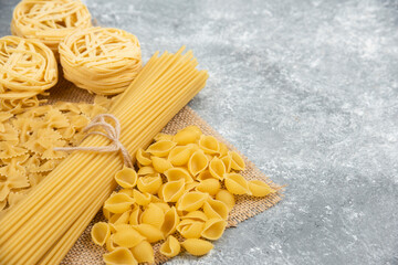 Raw pasta varieties on a piece of burlap