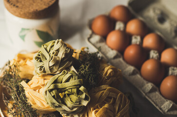Dry Taglatelle Pasta on the wooden table with bright background