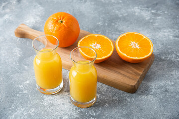 Glass pitchers of juice with slice of orange fruit