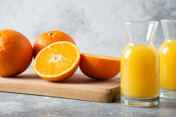 Glass pitchers of juice with slice of orange fruit