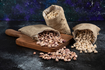 Sackcloth of dried raw beans placed on dark background