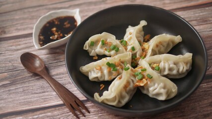 Steamed Gyoza or dumpling stuffed ground pork dipping with garlic soy sauce 