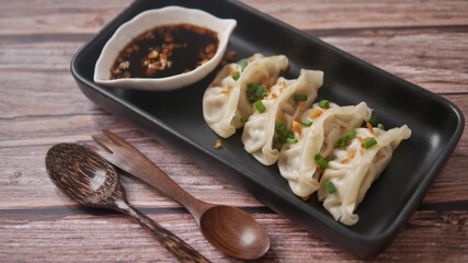 Steamed Gyoza or dumpling stuffed ground pork dipping with garlic soy sauce 