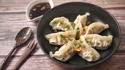 Steamed Gyoza or dumpling stuffed ground pork dipping with garlic soy sauce 