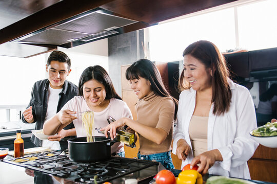 mexican family in the kitchen cooking together. Healthy food at home in Latin America