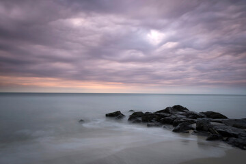 Fototapeta na wymiar USA, New Jersey, Cape May National Seashore. Sunrise on stormy beach landscape.