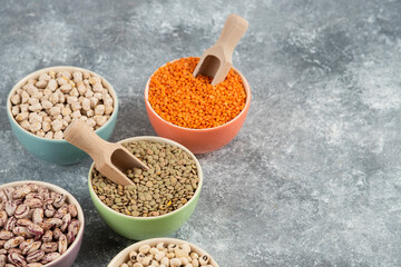 Assortment of raw dry legumes composition on marble surface