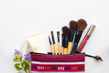 Naklejka premium sunscreen spf50,brush,lipstick and colorful bag set cosmetics beauty makeup of lifestyle woman arrangement flat lay style on background white