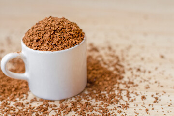 instant soluble coffee In a white ceramic mug on Wooden floor.