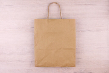 Paper bag on wooden background