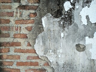 Background of old and dilapidated concrete wall show cracked surface bricks.