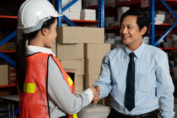 Warehouse manager and worker working in the storehouse . Logistics , supply chain and warehouse...