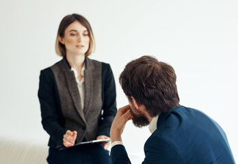 Woman and man in a jacket on a light background job interview