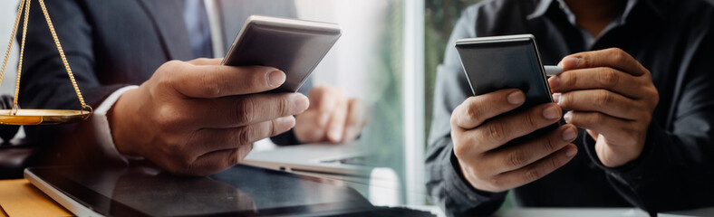 Naklejka premium businesswoman hand using smart phone,mobile p payments online shopping,omni channel,digital tablet docking keyboard computer at office in sun light