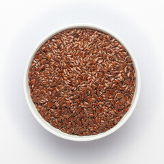 Organic Brown flaxseeds (Linum usitatissimum) or linseed in a white ceramic bowl , Top view