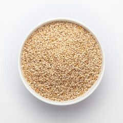 Organic White Sesame seeds(Sesamum indicum) or white Til with shell in white ceramic bowl