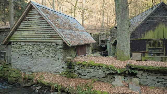 [4k] old water mill with wooden buildings and old stonewall