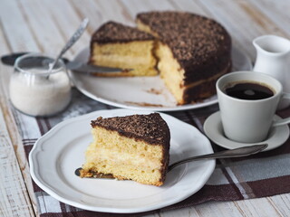 Freshly baked sponge cake Enchantress, covered with icing with grated chocolate.