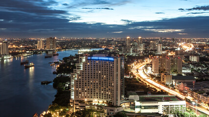 Fototapeta na wymiar Bangkok Transportation at Dusk with Modern Business Building along the river (Thailand)