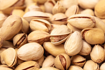 Close-up of fresh pistachio nuts as background.