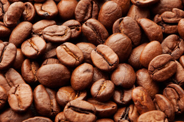 Close up of fresh, roasted coffee beans. Background, texture or pattern of brown aromatic coffee beans 