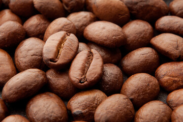 Close up of fresh, roasted coffee beans. Background, texture or pattern of brown aromatic coffee beans 