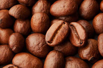 Close up of fresh, roasted coffee beans. Background, texture or pattern of brown aromatic coffee beans 
