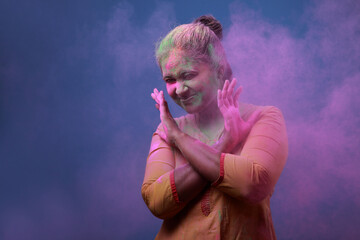 Woman plays with Holi festival colours.Concept for Indian festival Holi