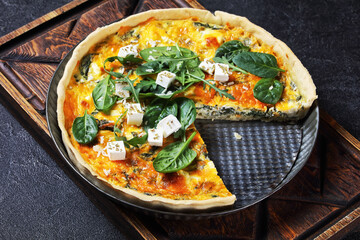 feta spinach parmesan quiche in a baking dish
