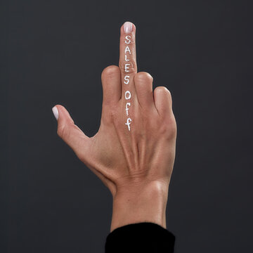 Sales off inscription on woman middle finger