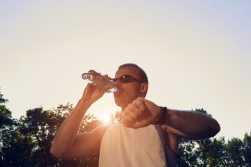 Sporty young adult man training in the park.