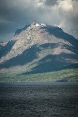 Morning light on a mountainside through the clouds in Glacier National Park, Montana.