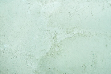 celadon green concrete old wall. cement texture. scuffs and cracks