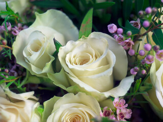 bouquet arrangement of white roses with small pink flowers